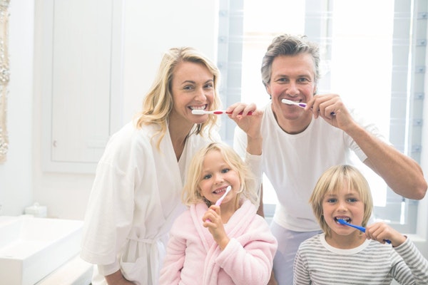 family brushing their teeth together