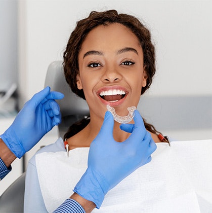 Dentist placing an Invisalign aligner