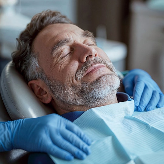 sedated man smiling in dentist chair
