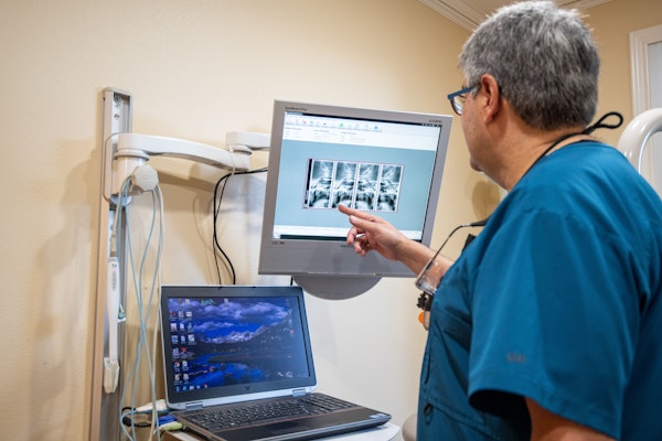 Dr. Teja looking over someone's teeth