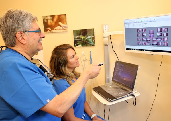 Dr. Teja with a dental technician