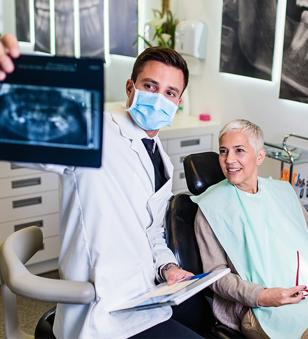 Dentist and patient looking at X-ray