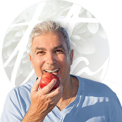 Man with dentures eating an apple