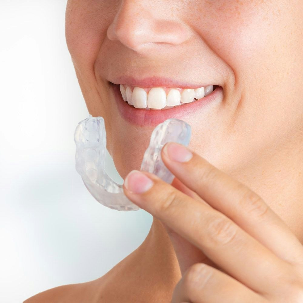 woman holding oral appliance