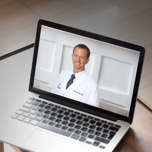 Dr. Dolgos's TMJ Academy informational video on laptop