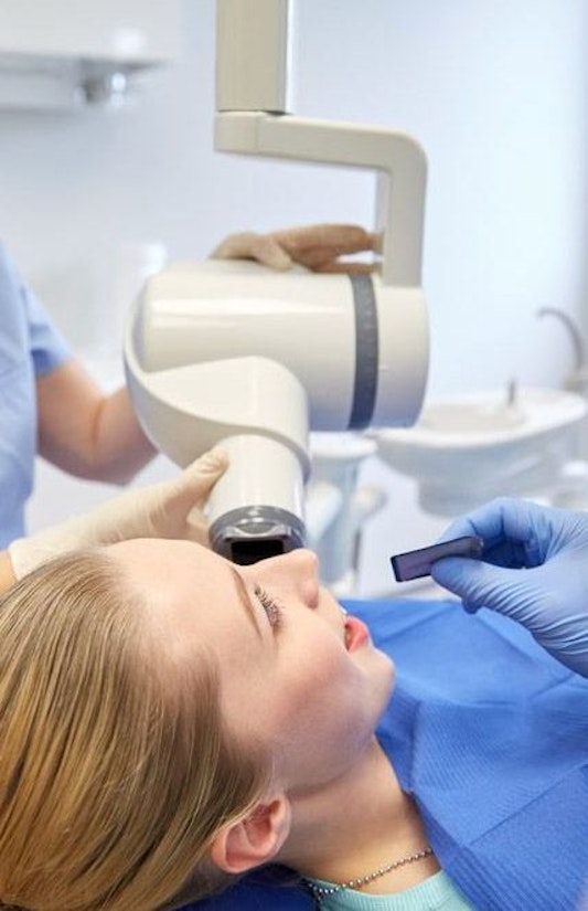 Technician taking digital impressions of patient's teeth