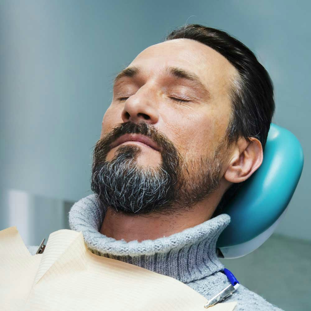 sleeping man in dental chair