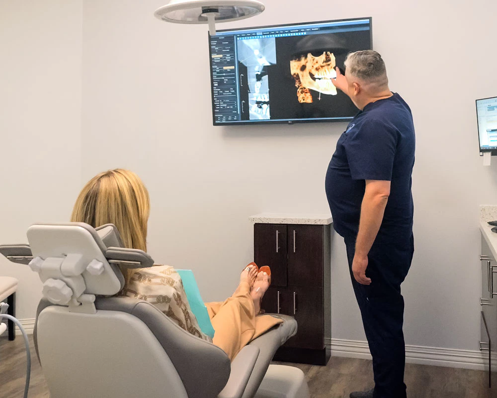 Team at Advanced Oral Surgery reviewing 3D imaging