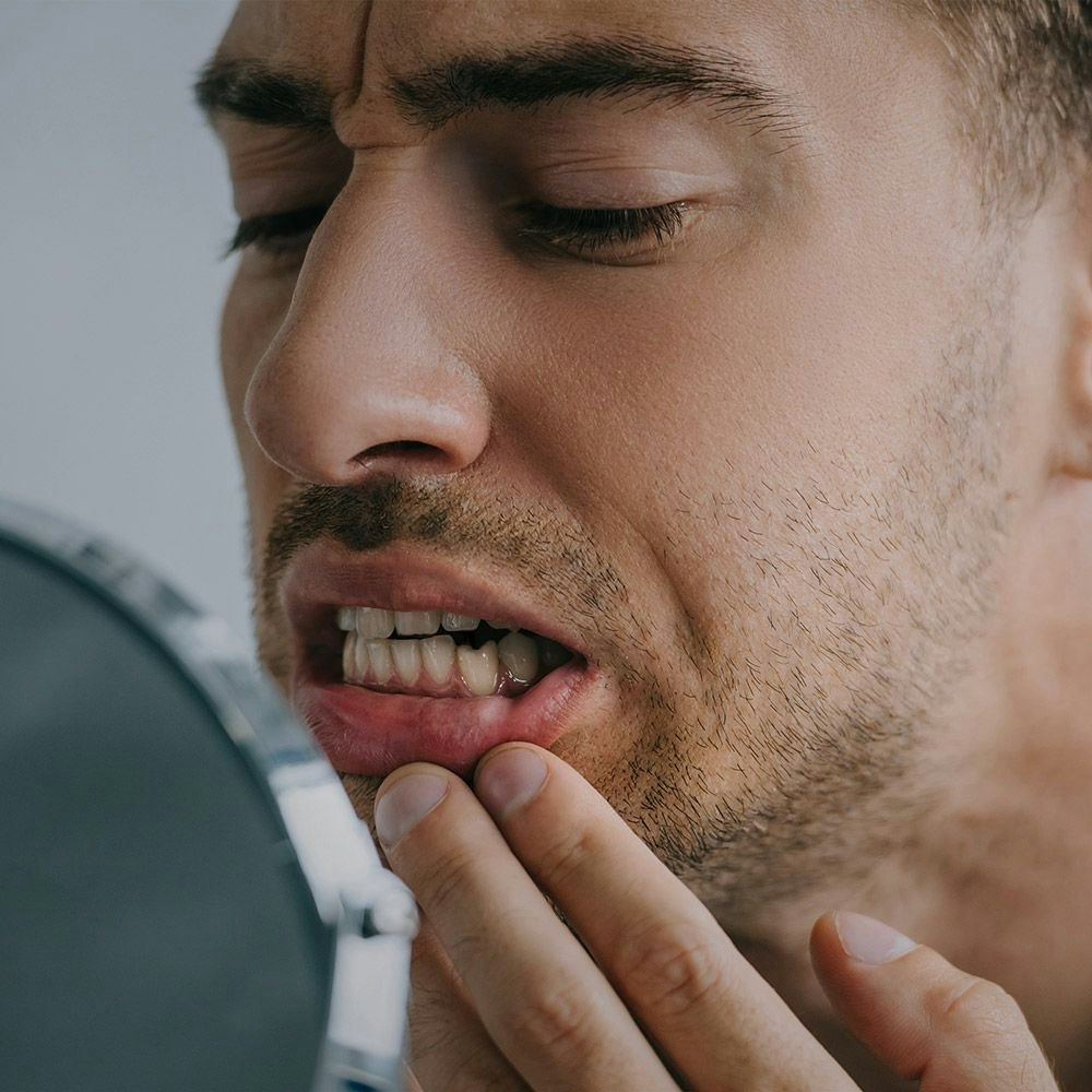 man examining damaged tooth