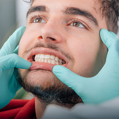 Man getting his gums checked by his dentist