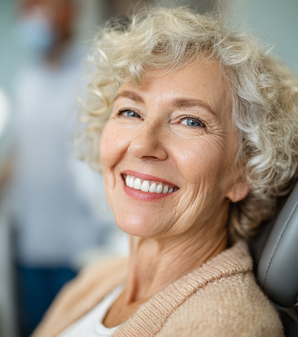 Woman smiling after full mouth reconstruction