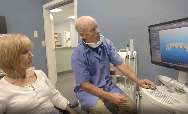 Dr. reviewing dental scan with patient