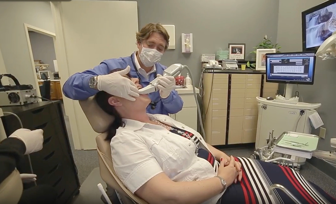 Dr. using an intraoral scanner on patient