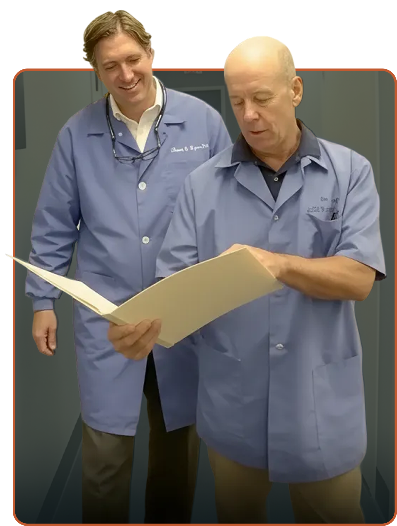 Doctors walking down the hall looking at a folder