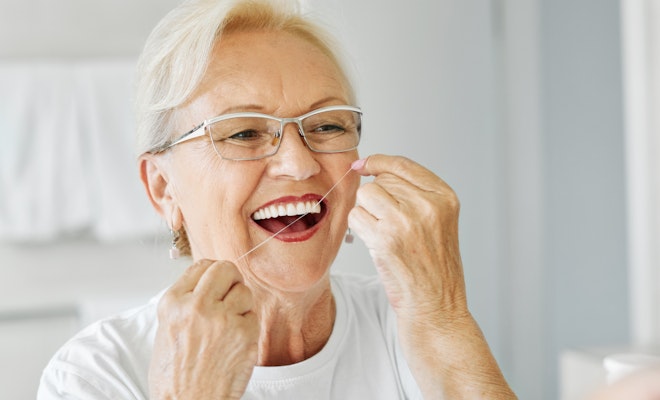 Mature woman flossing