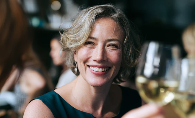 middle-aged woman smiling at dinner