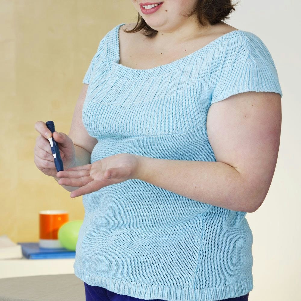 Woman testing blood sugar levels