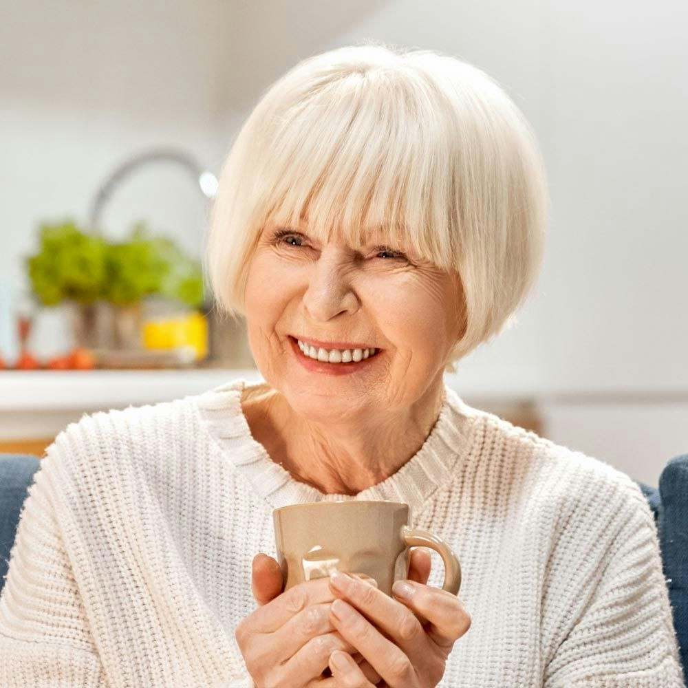Older woman smiling comfortably at home