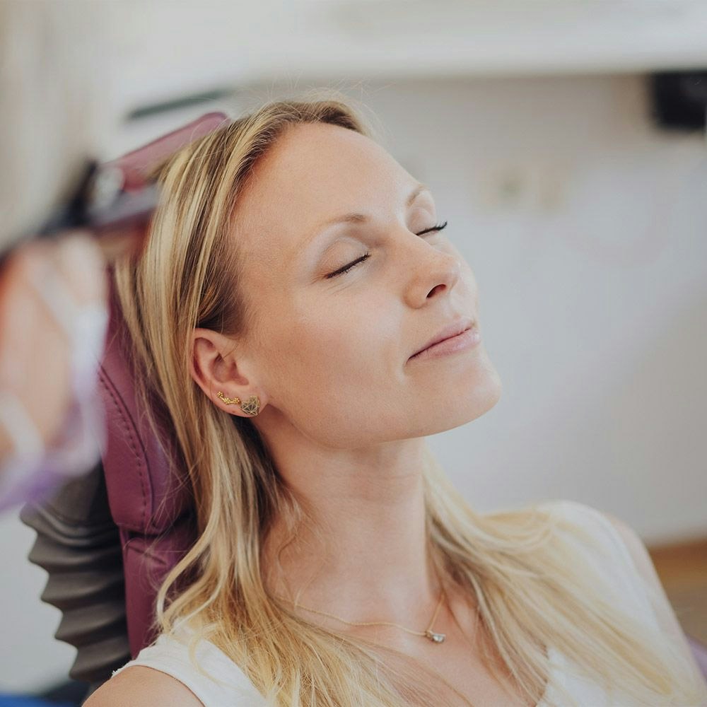 Woman wearing nitrous oxide mask