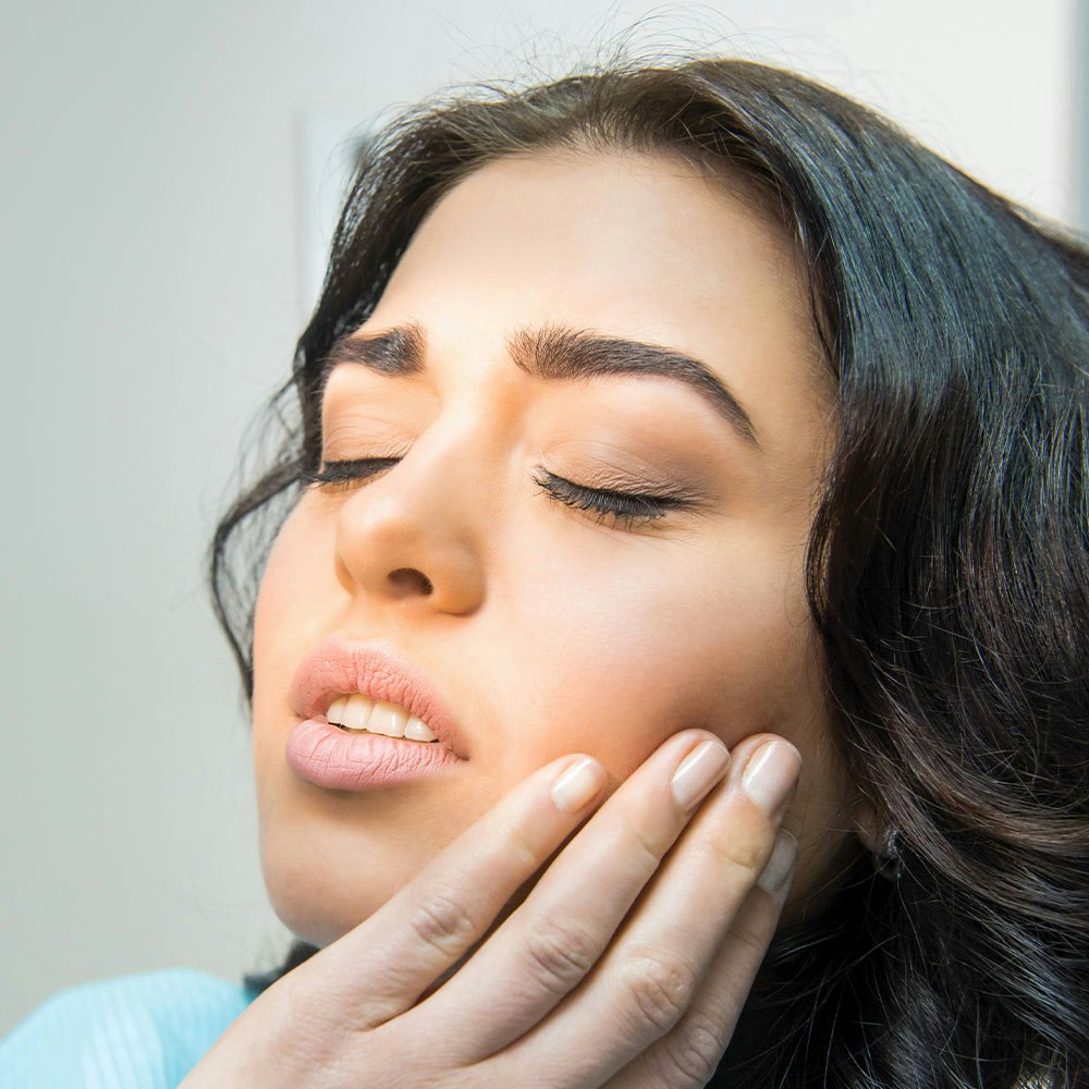 Woman Holding her Jaw in Pain