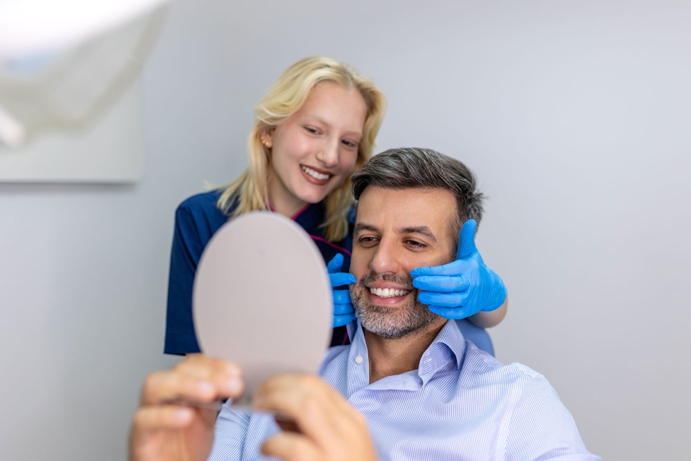 man smiling with a dentist
