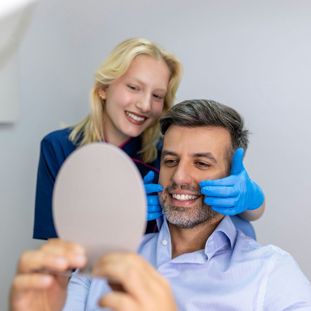man smiling with a dentist