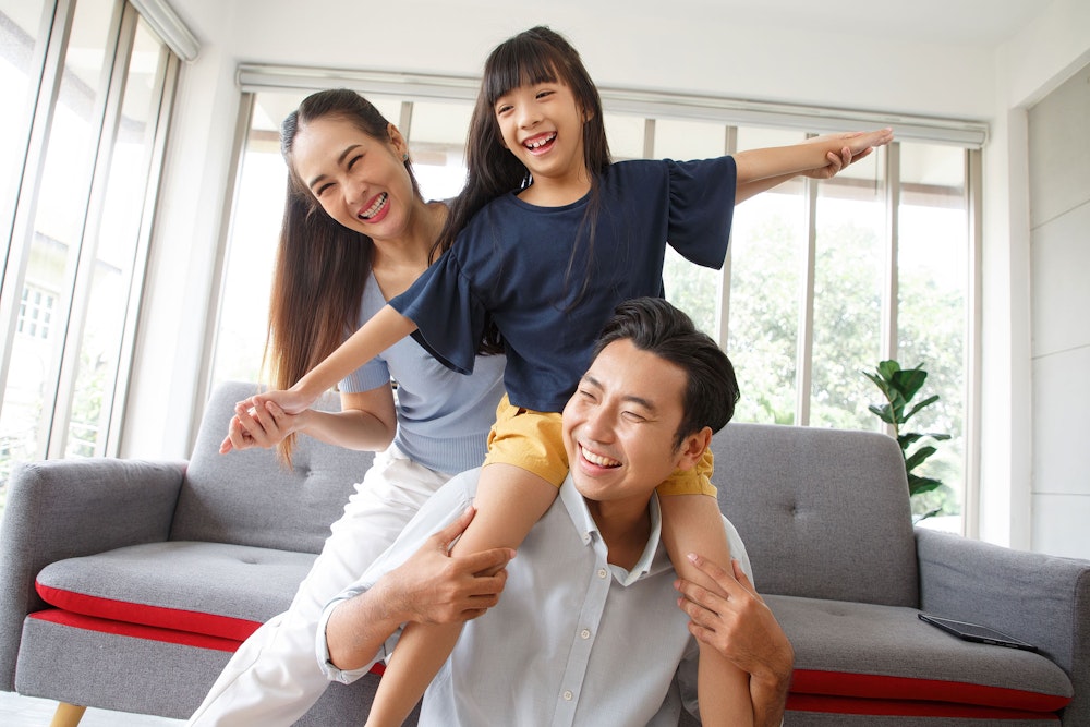 smiling parents with their daughter