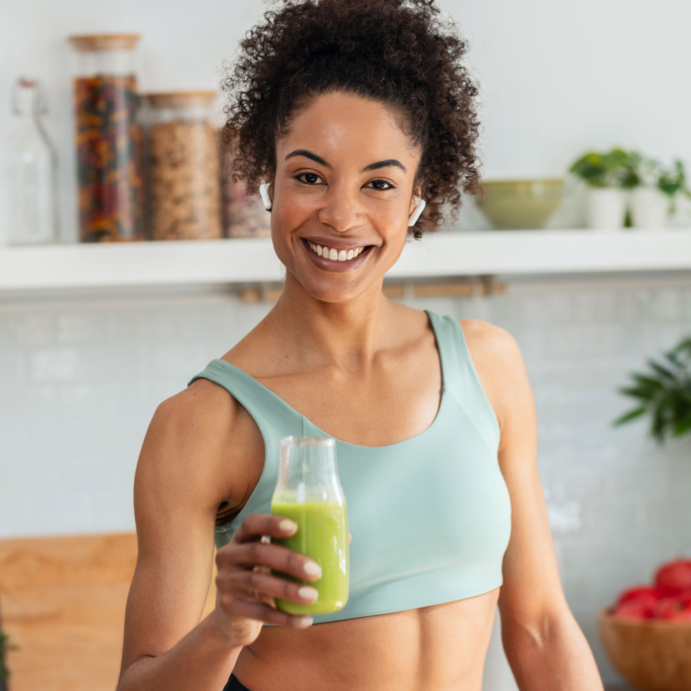 smiling woman with green juice