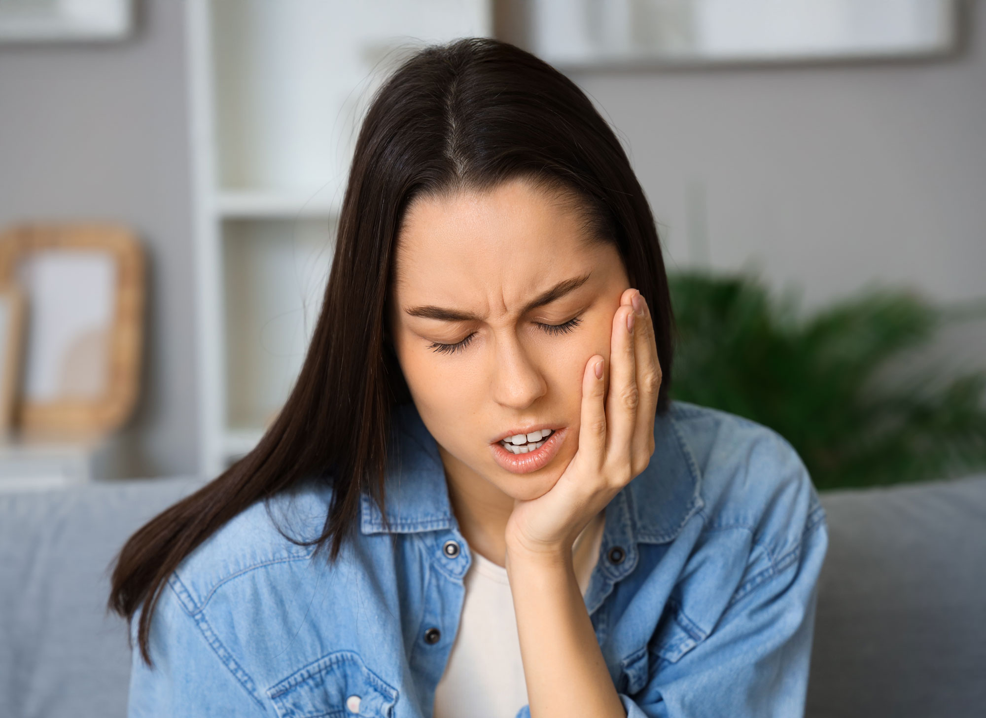 woman with jaw pain from wisdom tooth