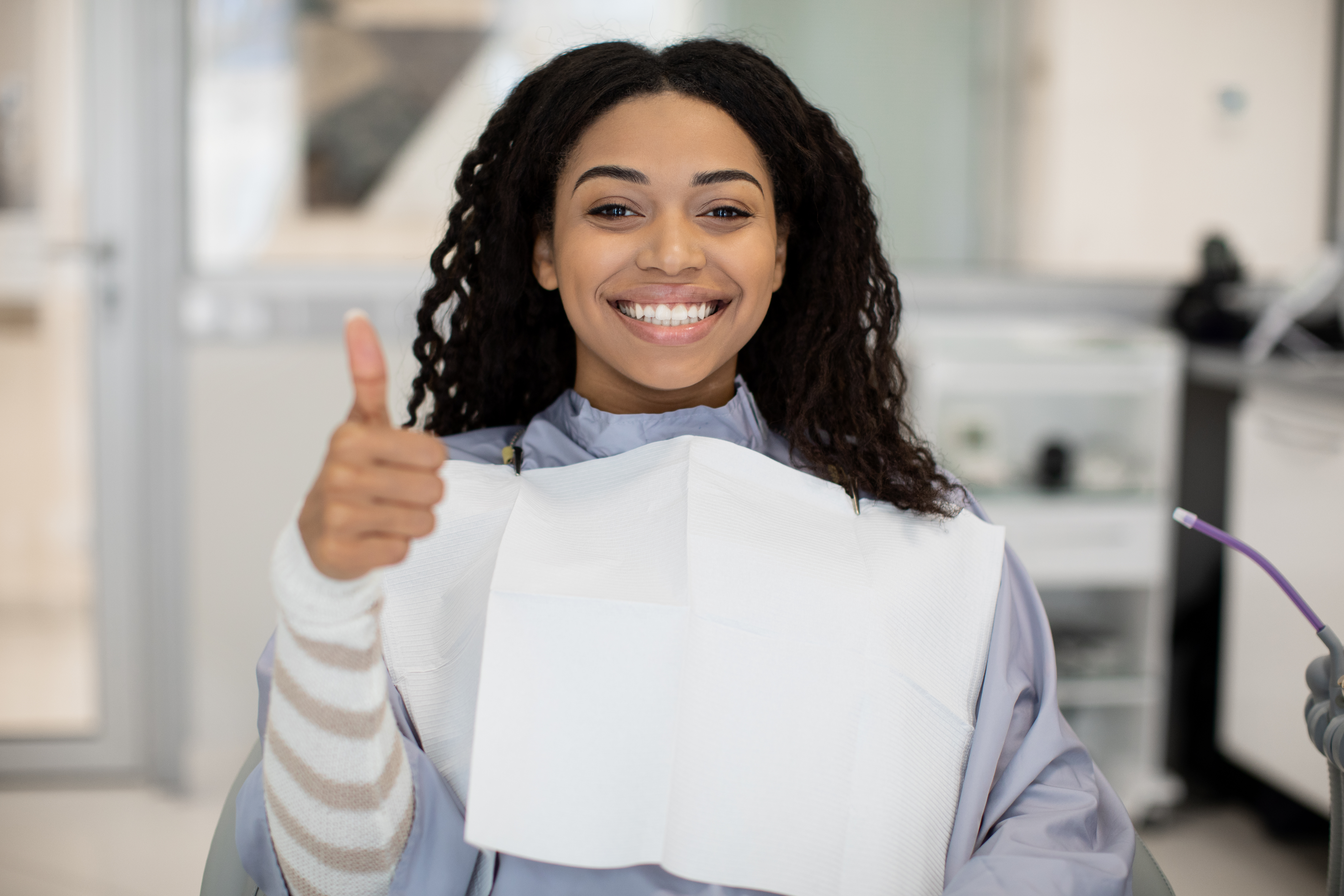 smiling young woman giving a thumbs-up