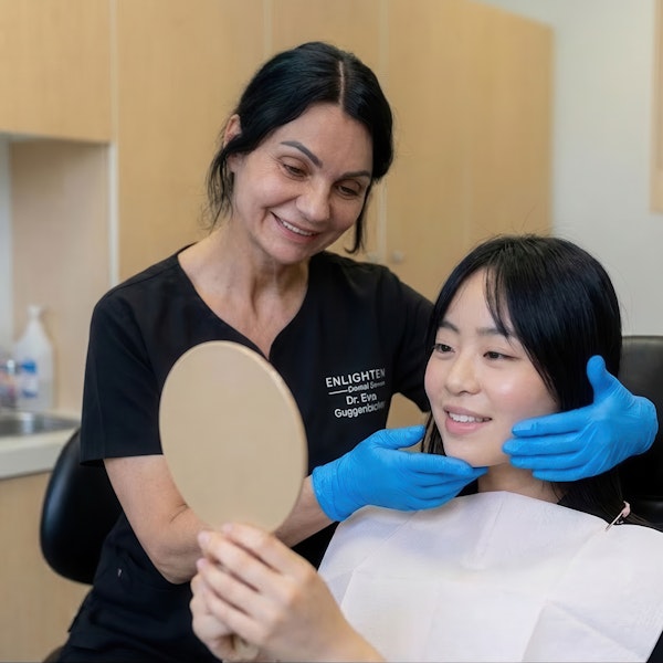 Dr. Eva Guggenbichler and patient looking at mirror