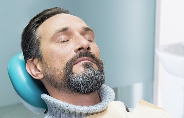 sedated man in dentist's chair