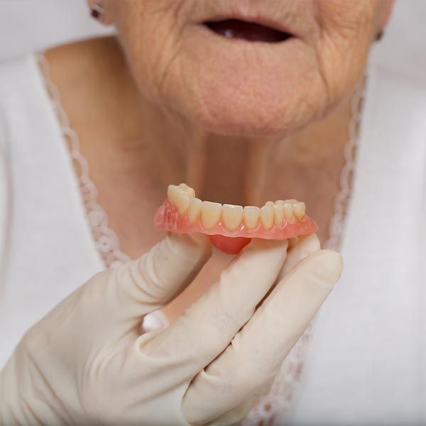 Older woman and denture