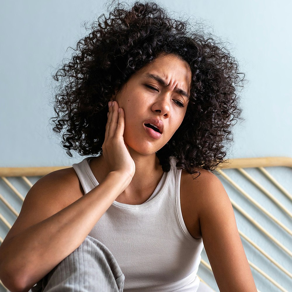a woman with jaw pain
