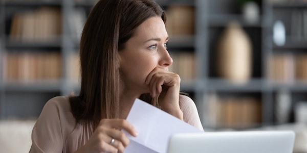 worried woman doing bills