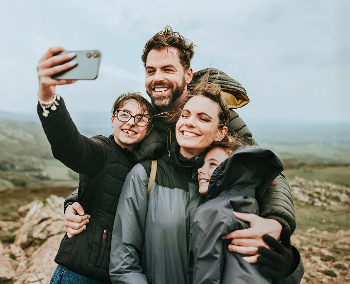 Family smiling, taking a picture together