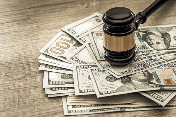 Gavel on top of cash