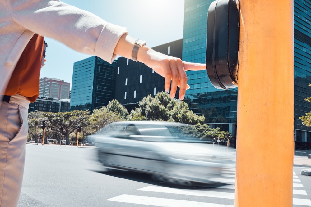 pedestrian hitting the light to walk
