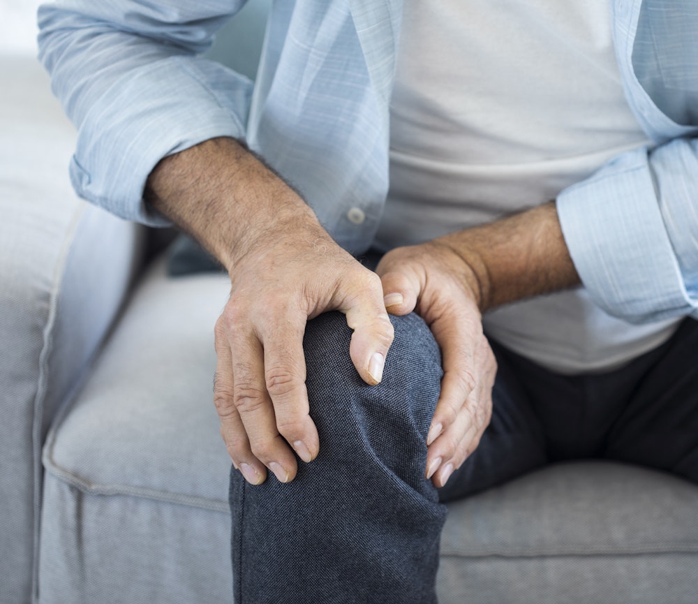 Man clutching knee in pain after a slip and fall accident
