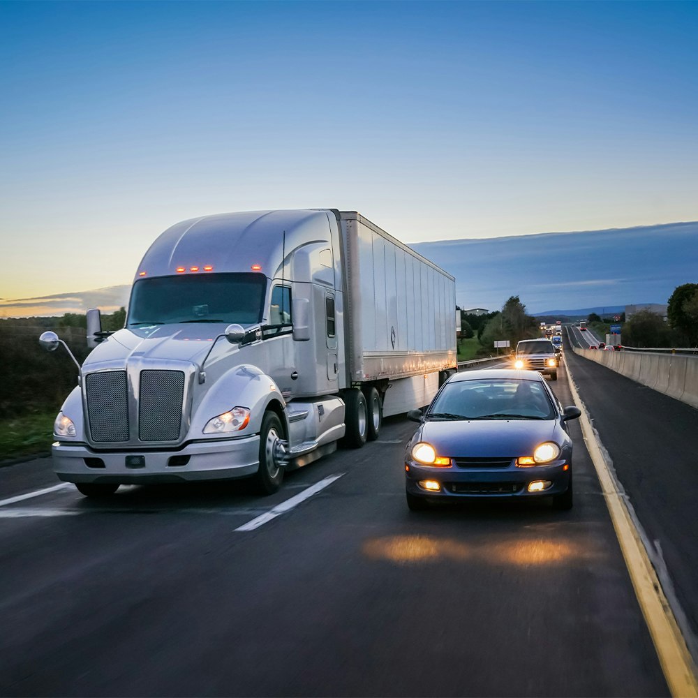 Cars next to semi truck on highway