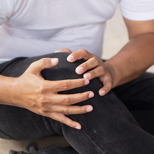 A man holding knee after tripping