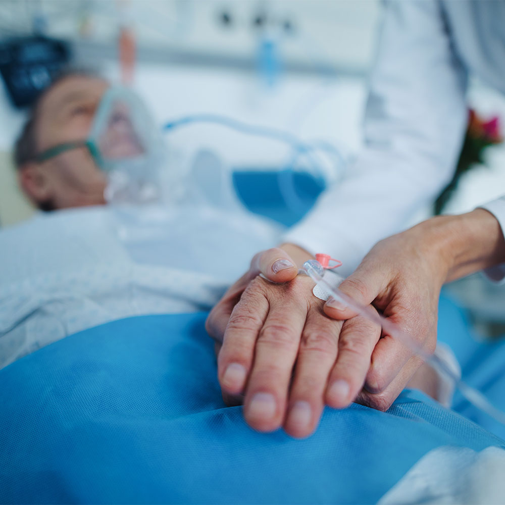 Nurse applying cannula at patient's hand