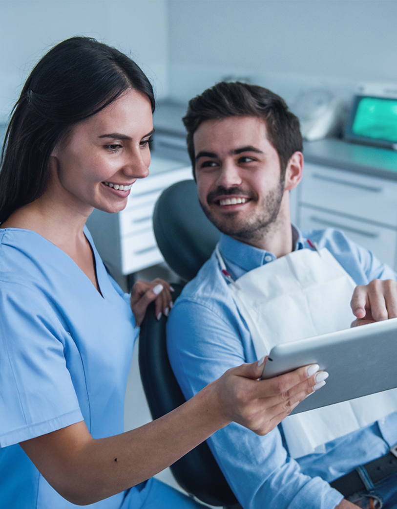 patient smiling at dentist from dental chair