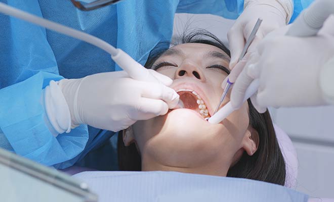 woman undergoing scaling and root planing treatment