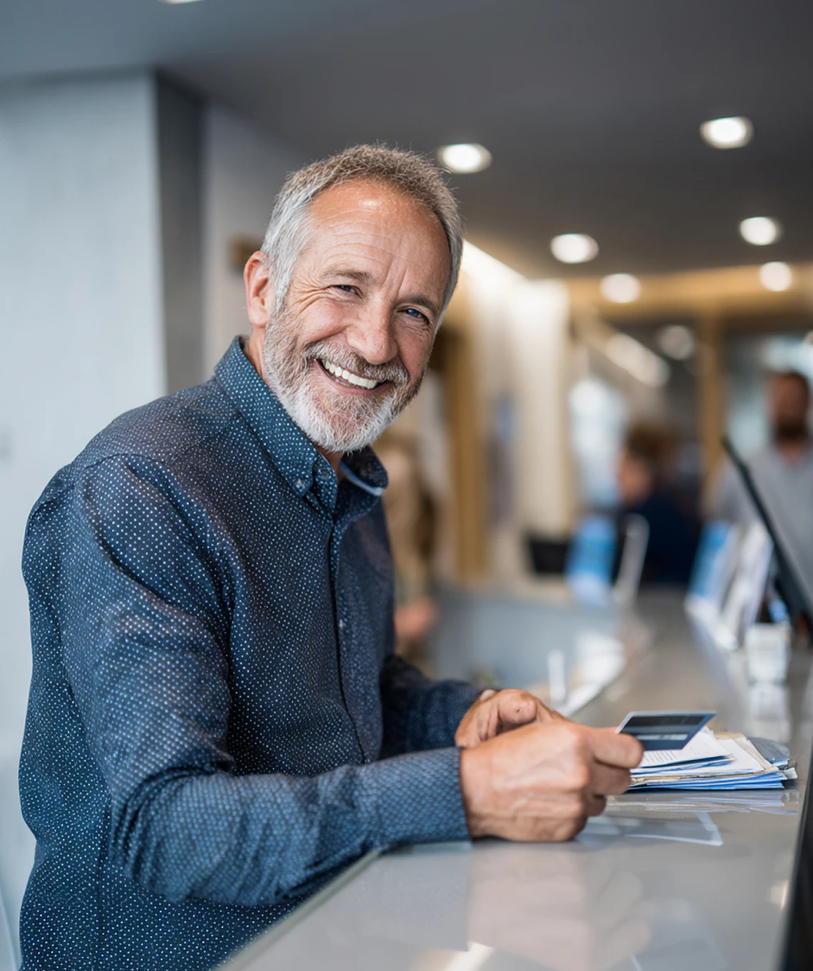 smiling man checking in at dentist