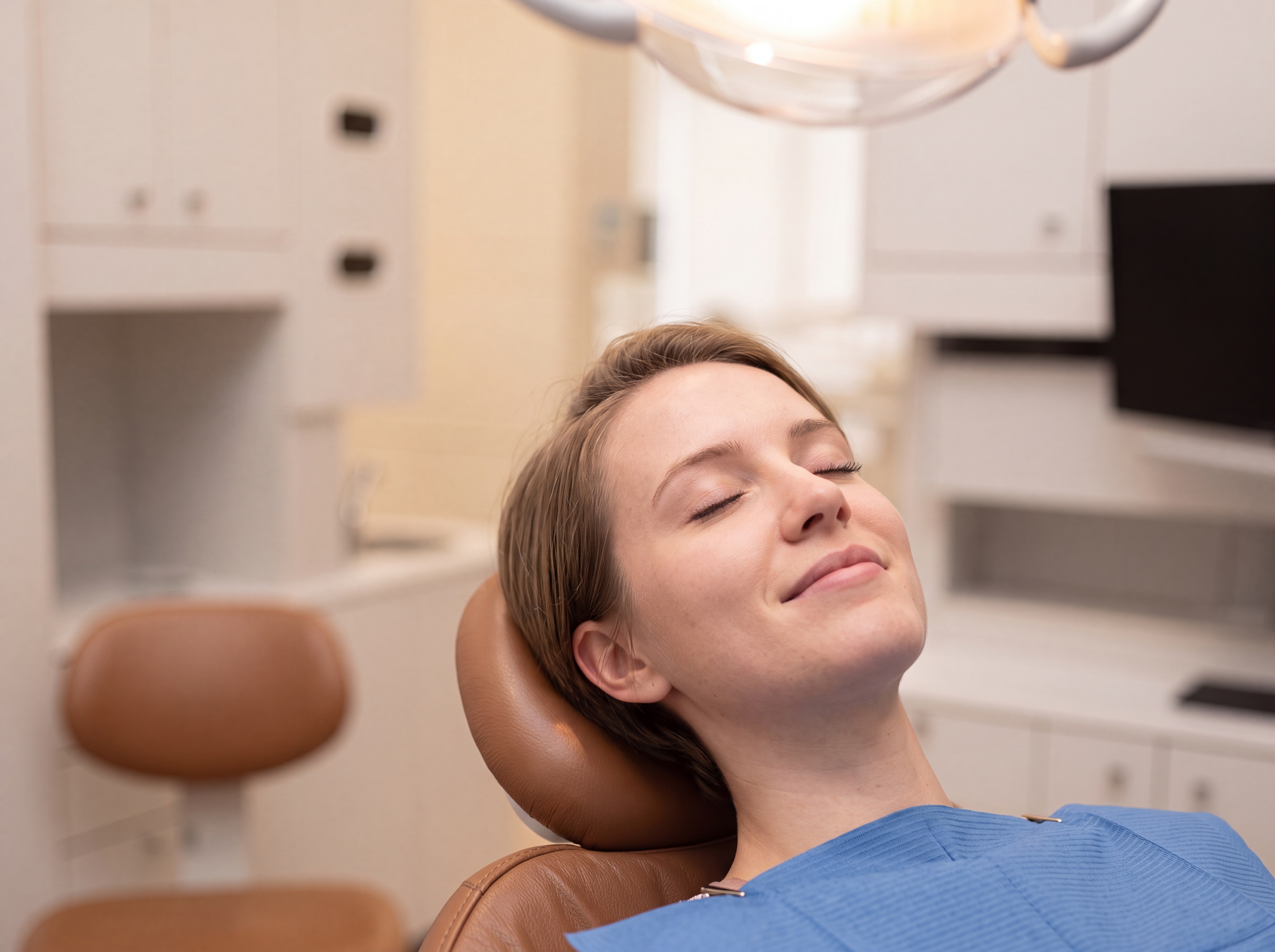 woman in dental chair smiling and relaxed