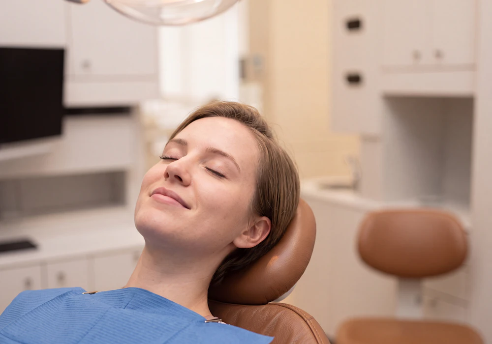 woman in dental chair smiling and relaxed