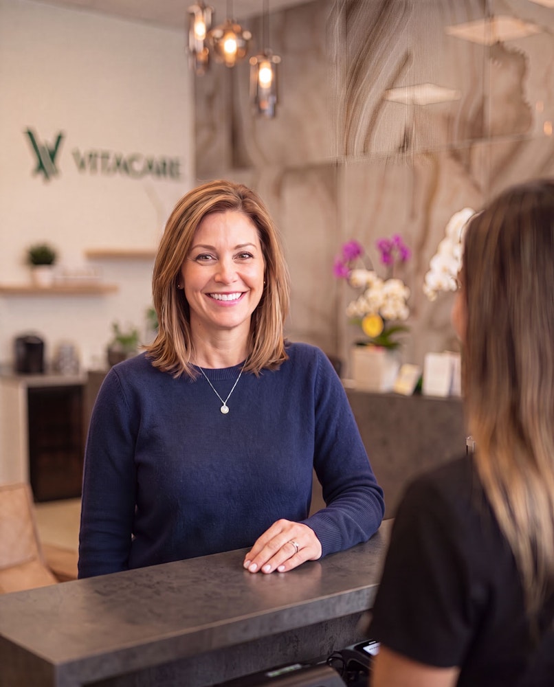 Smiling dental patient at the front desk