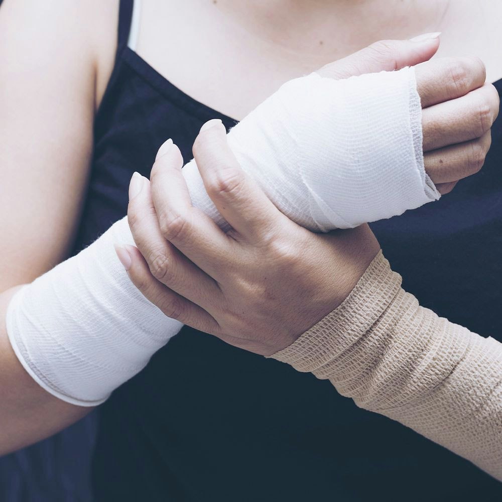 Woman holding wrist in cast