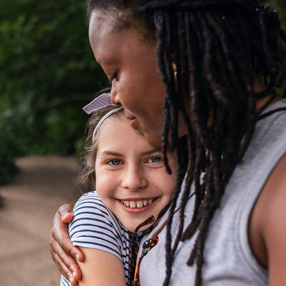 Daughter hugging mother